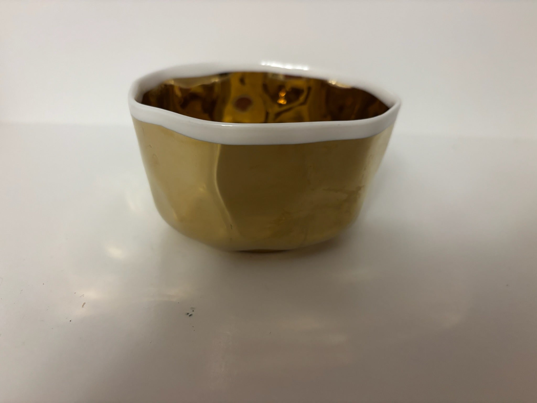 small ceramic bowl, metallic gold with white interior and rim
