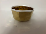 small ceramic bowl, metallic gold with white interior and rim