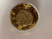 small ceramic bowl, metallic gold with white interior and rim