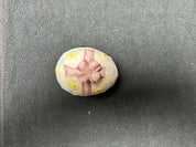 Sm. pink ribbon egg w/blue/yellow flowers