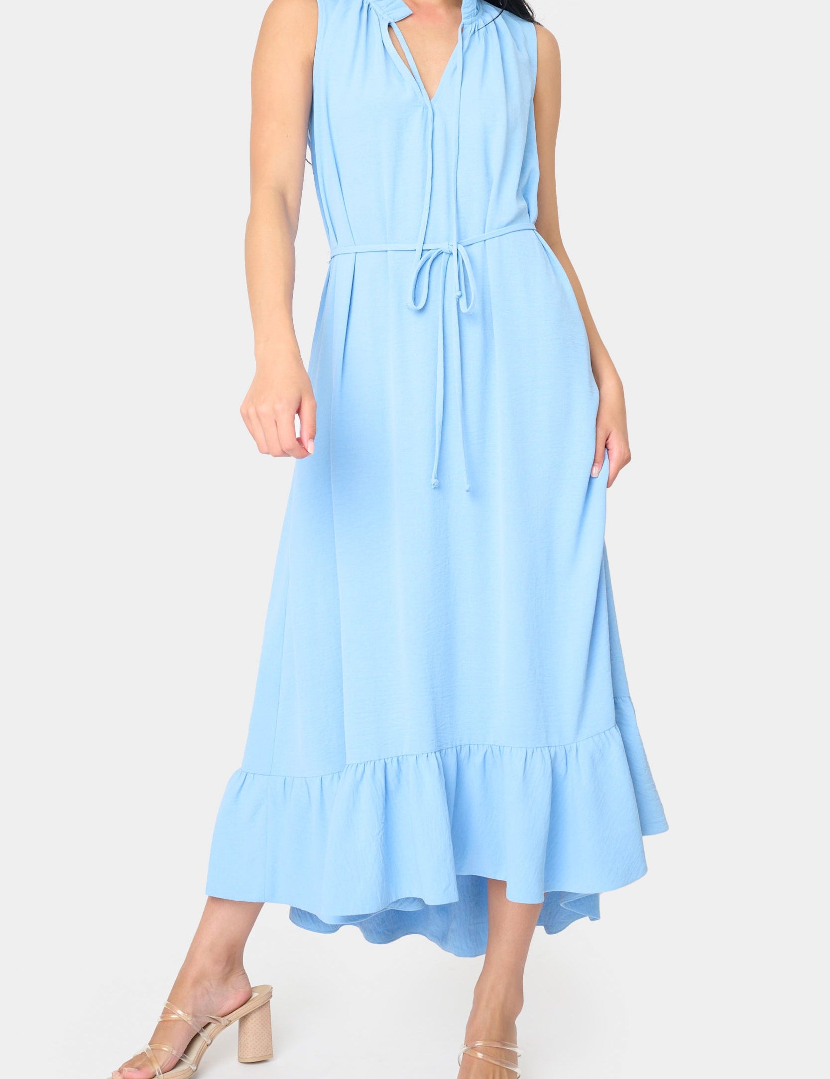 Sky blue sleeveless midi dress with split tie neckline, tie waist, oversized ruffle hem, and hi-low silhouette, styled for a special occasion – JSQ Mercantile – a women’s boutique and gift shop in La Grange, IL