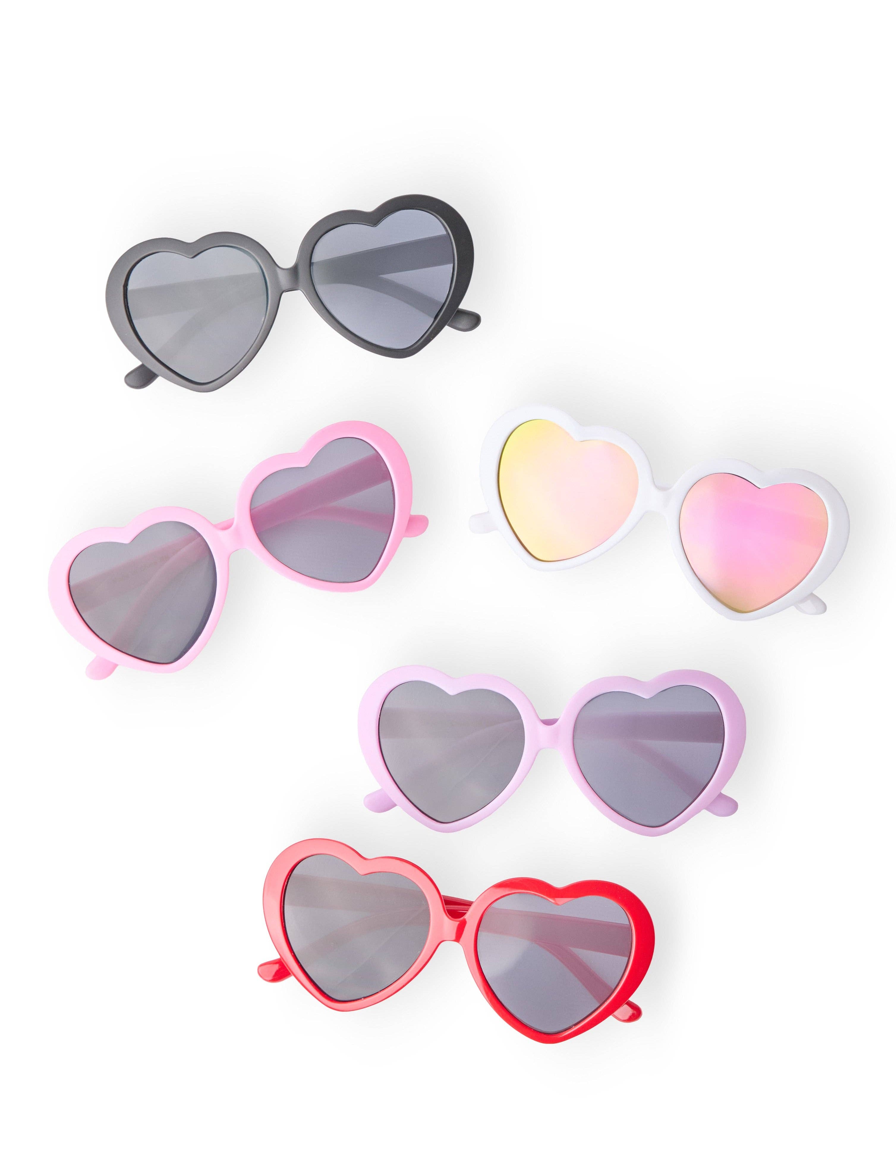Girl wearing heart shaped sunglasses from JSQ Mercantile – a women’s boutique and gift shop in La Grange, IL.