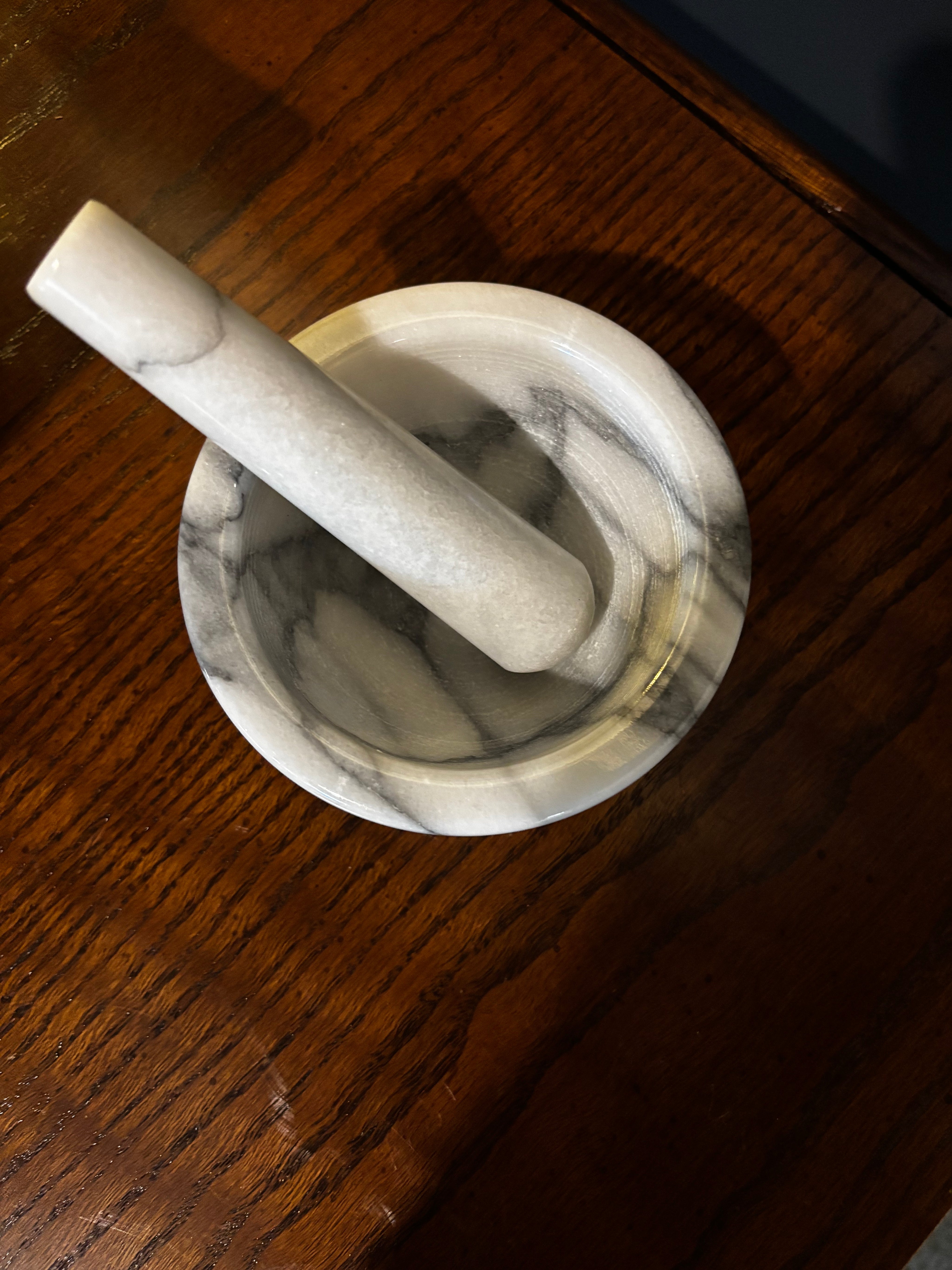 white marble mortar and pestle